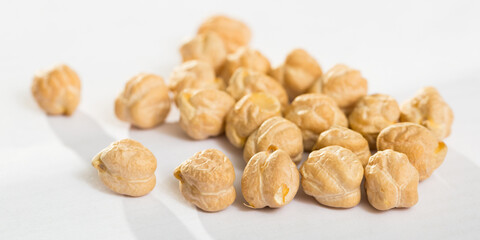 Chickpea seeds closeup on white surface. Organic food for healthy eating..