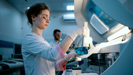 A scientist uses lab equipment for an experiment, working with test tubes and samples. Concept...