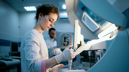 Research scientists work in a laboratory with modern equipment. Analyzes samples and genetic...