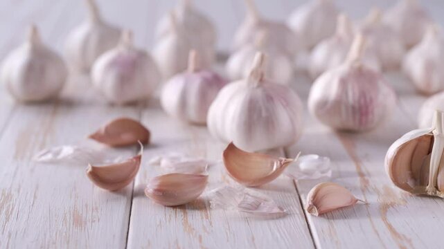 organic garlic on a white kitchen table.
fresh garlic on a white wooden table.
