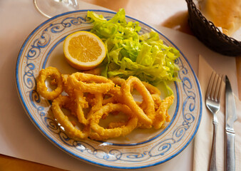 Calamares a la romana fried squid on plate. Traditional spanish dish. High quality photo