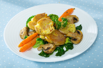 Dish of australian cuisine, crash hot potatoes with mushrooms and vegetables at plate