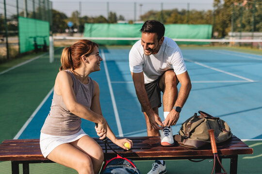 Young couple playing tennis outdoors enjoying a fun summer game