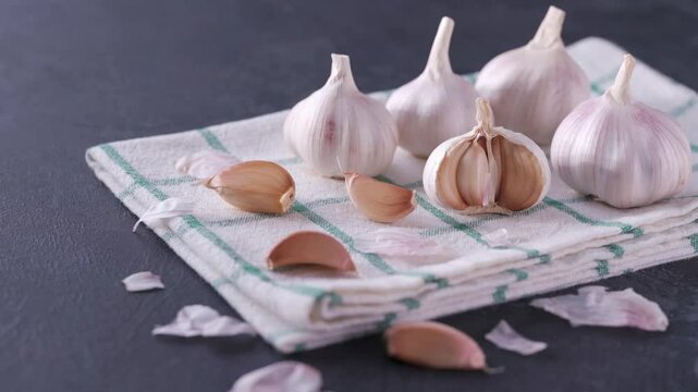 organic garlic on a black stone table.
fresh garlic on a black table.