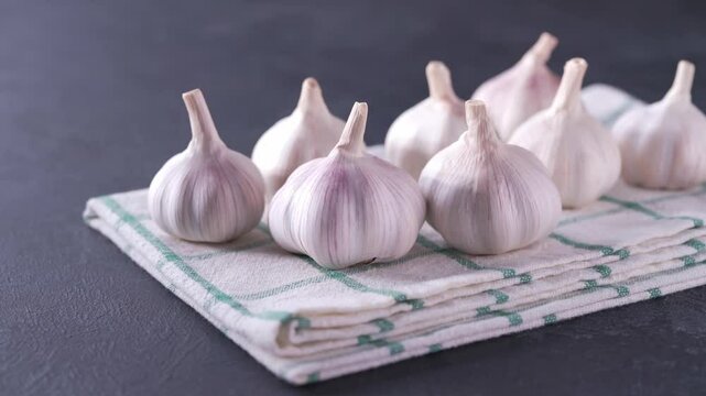 Fresh garlic bulbs on a black stone table. organic garlic bulbs on a black table.