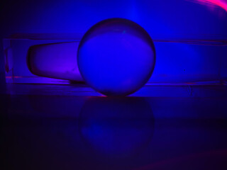 A colorful ball is sitting on a glass pedestal. The colors of the ball and the pedestal are vibrant and eye-catching. Scene is energetic and lively, as if the ball is a symbol of fun and excitement