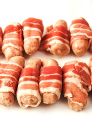 Pigs in blanket on a white color background. Simple pork meat food for a party or starter.