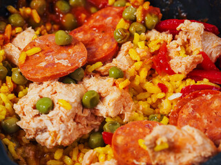 Spanish paella dish with spicy chorizo sausages. Close up. Popular traditional food made of fine rice and other ingredients.