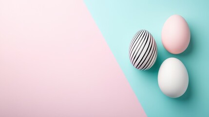 Happy Easter. Three pastel colored Easter eggs with intricate patterns on pale pink and green background. Top view, copy space for text