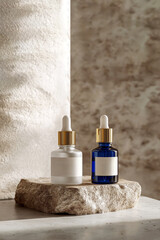 Two dropper bottles, one white and one blue, resting on a marble slab atop a stone, creating a luxurious and natural aesthetic for beauty product presentation