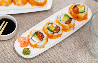 Japanese california roll masago caviar with salmon, avocado and cheese with soy sauce