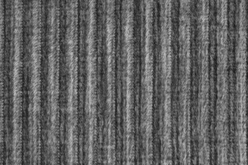 Ridge macro texture of velour corduroy black cloth. Large ribbed, coarse weaving velveteen, striped upholstery texture fabric background, furniture textile material, design, decor