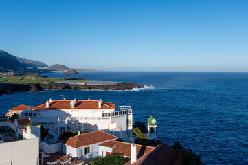 View on colonial old town Garachico, mountains, ocean, banana plantations, on Tenerife as seen from Playa San Marco, Canary islands, Spain in winter