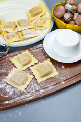 Italian food, fresh home made stuffed pasta ravioli dumplings with ricotta soft cheese and champignons porcini mushrooms, Parma, Emilia Romagna, Italy