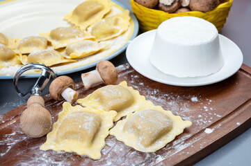 Italian food, fresh home made stuffed pasta ravioli dumplings with ricotta soft cheese and champignons porcini mushrooms, Parma, Emilia Romagna, Italy