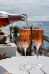 Celebration, birthday party, drinking of rose cava or champagne sparkling wine in vacation resort Costa Adeje, Tenerife, Canary islands winter sun vacation, Spain