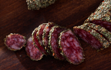 Sliced spanish sausage fuet with herbs. High quality photo