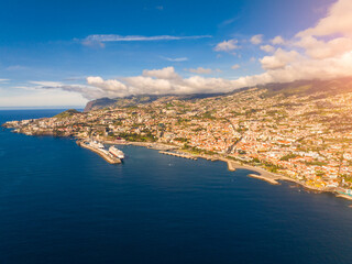 Breathtaking aerial view of Funchal along the picturesque coastline with vibrant city life and...