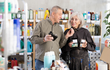 Husband and wife choose cosmetics and perfume together in a supermarket