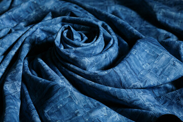 Blue printed thick elastic neoprene fabric for making a casual or sporty clothes. Close up of...