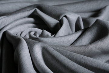 Grey toned thick elastic neoprene fabric for making a casual or sporty clothes. Close up of texture...