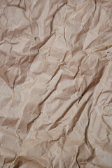 grey recycled kraft paper crumpled close up background. Paper for packaging goods. Paper for creativity. Waste paper recycling.