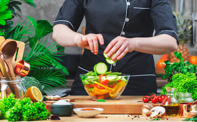 Home Chef places sliced ​​zucchini into bowl for prepare ratatouille. Cozy kitchen with wooden...