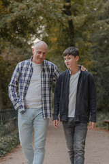 Obraz premium Father and son walking in the field, talking