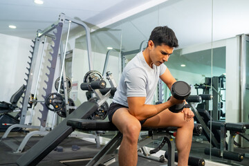 Healthy Asian man athlete do sport training workout exercise weight lifting dumbbell at fitness...