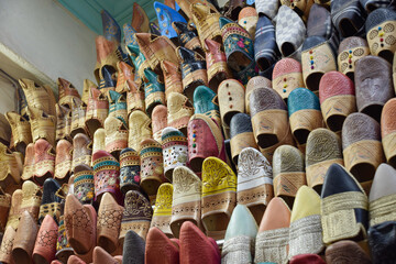 Slippers or sandals of many colors hung from street stalls in Marrakech's souk