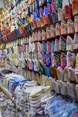 Slippers or sandals of many colors hung from street stalls in Marrakech's souk