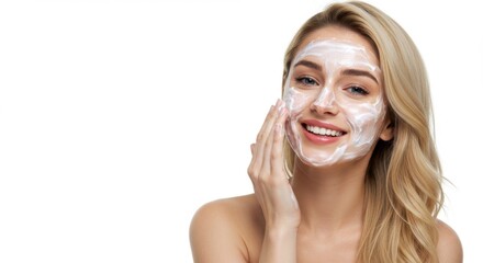 A happy young woman cleanses her skin with a gentle facial foam, the model applies the cleanser to her skin and smiles.
