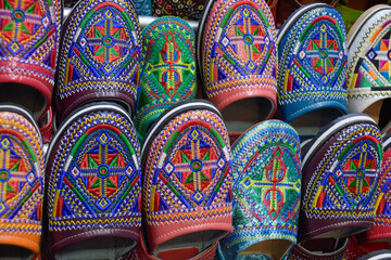Close up view of Slippers or sandals of many colors hung from street stalls