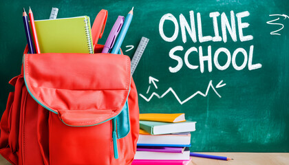 School supplies and online school text on green chalkboard