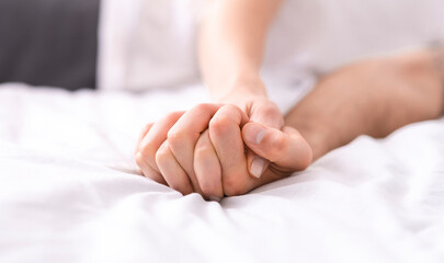 Passionate couple making love in bed, intimate foreplay of two lovers, free space