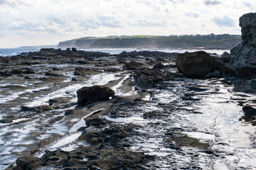 This dramatic coastal scenery from Kilcunda, Victoria Australia, features a rugged shoreline of...
