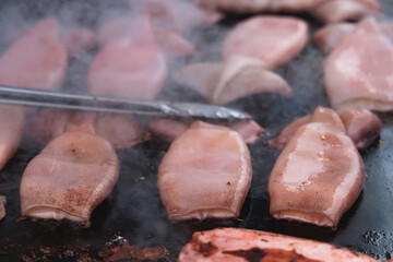 Ikayaki, Grilled roasted Squid with sauce - popular Japanese Street Food, variety of different traditional food snack selection in Tokyo, Japan, street market with local vendor stalls cooking