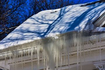 Ice dams in roof gutters from melting snow can cause water damage inside home, insufficient attic insulation is usually the cause.