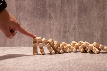 insurance with hands protect domino. Businessman hands stop dominoes falling in business crisis.