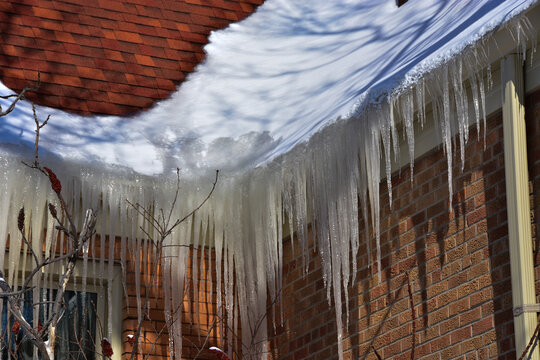 Ice dams in roof gutters from melting snow can cause water damage inside home, insufficient attic insulation is usually the cause.