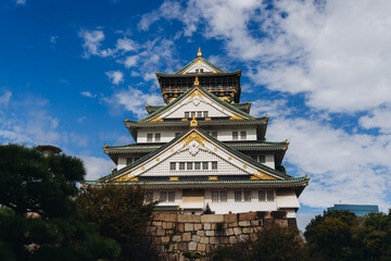 Fototapeta premium Osaka Castle, Osaka city, Japan, summer landscape vibrant view with a blue sky, Osakajo castle building, Kansai region, Osaka prefecture, travel to Japan