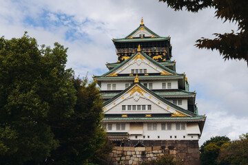 Fototapeta premium Osaka Castle, Osaka city, Japan, summer landscape vibrant view with a blue sky, Osakajo castle building, Kansai region, Osaka prefecture, travel to Japan