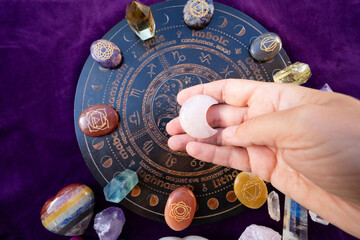 Gemstones minerals stones and obelisks over astrology desk. Witchcraft, herbal medicine and...