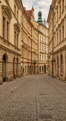 Fototapeta premium Charming empty street in historic european city with classic architecture