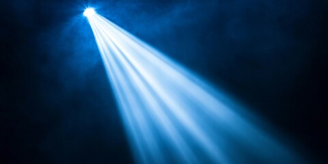 Blue spotlight beam stage smoky dark background