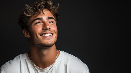 Naklejka premium Smiling young man in casual beige t-shirt and glasses, quarter view,portrait with soft lighting