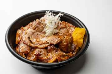 Authentic Japanese Butadon: A Donburi Bowl Filled with Fluffy Rice and Generous Portions of Tender Pork Belly Sautéed in a Rich, Sweet, and Savory Sauce, Garnished with Pickled Ginger and Green Onions