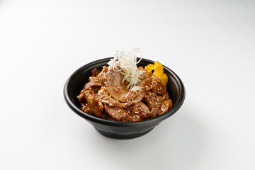 Authentic Japanese Butadon: A Donburi Bowl Filled with Fluffy Rice and Generous Portions of Tender Pork Belly Sautéed in a Rich, Sweet, and Savory Sauce, Garnished with Pickled Ginger and Green Onions