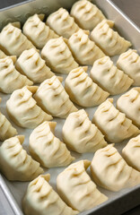 Close-Up of Uncooked Dumplings: Delicate Pleats and Smooth Texture