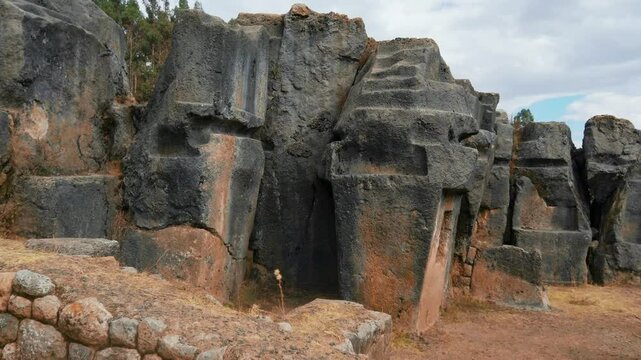 Ancient Inca stone structures and carved stairways at Inkilltambo, Cusco, Peru.